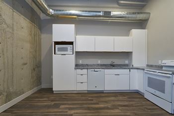 Kitchen with white cabinets and white appliances